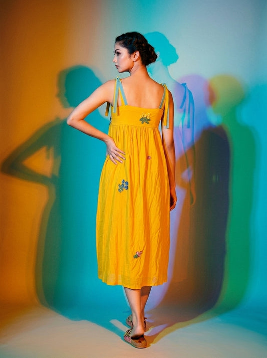 Woman wearing a flowing saffron-yellow embroidered midi dress with thin straps and a softly gathered neckline. - Robe BLOOM - S - ALTER EGO