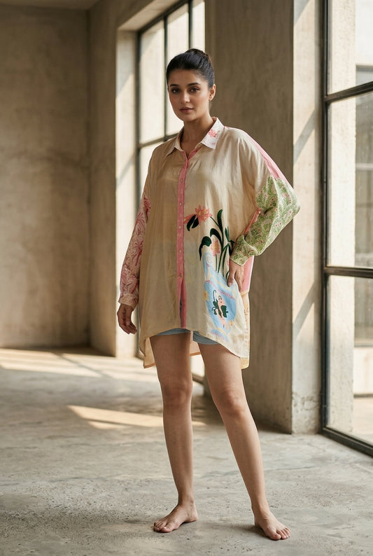 Woman wearing a loose beige silk shirt dress with long sleeves, colorful floral print, and a relaxed above-knee hem. - Chemise GRACES - XS - ALTER EGO