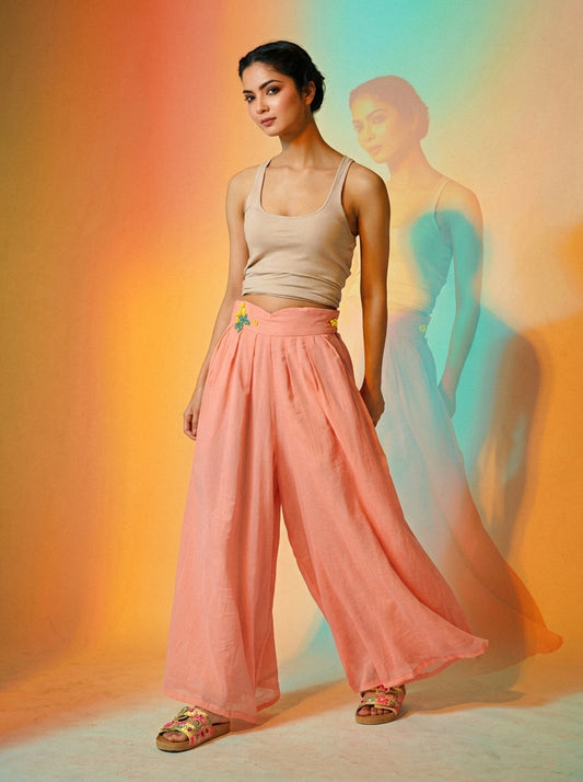 Woman wearing a coral-pink high-waisted wide-leg culotte jumpsuit with a fitted beige top and flowing fabric. - Pantalon BLOOM - S - ALTER EGO